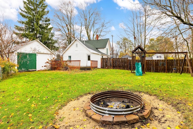 view of yard with a storage shed, a playground, and a wooden deck