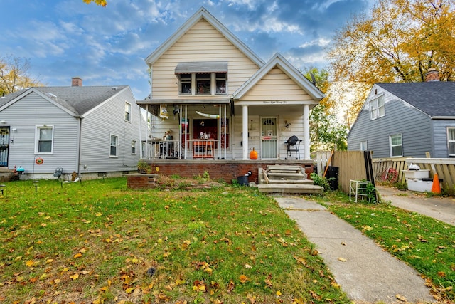 bungalow with a front lawn and a porch