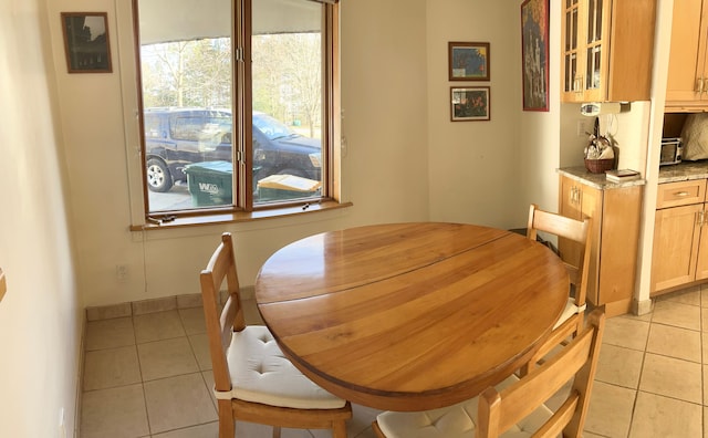 dining area with light tile patterned floors