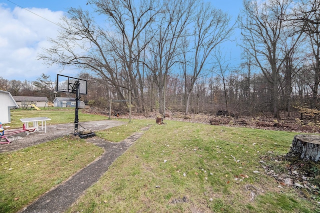 view of yard with basketball court