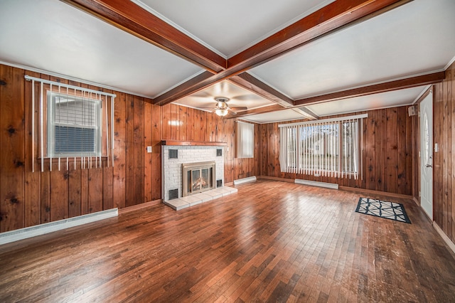 unfurnished living room with hardwood / wood-style floors, beam ceiling, and wood walls