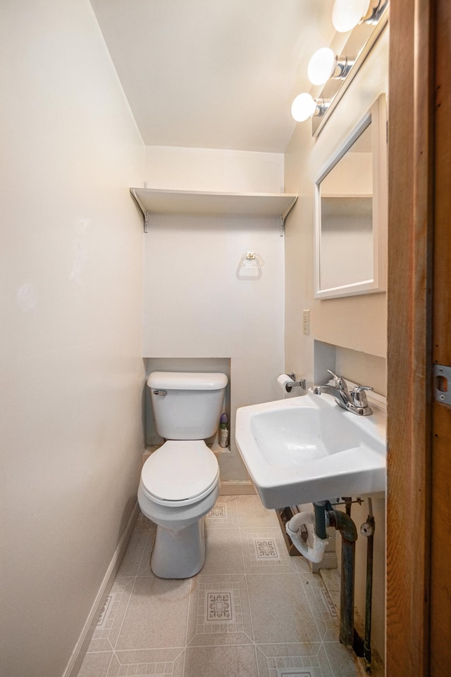 bathroom featuring tile patterned floors, toilet, and sink