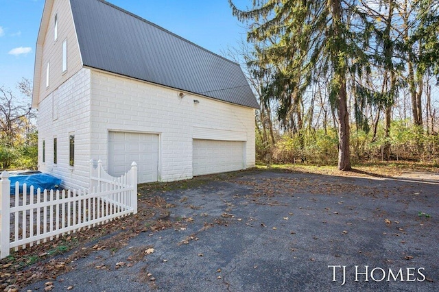 view of side of home featuring a garage