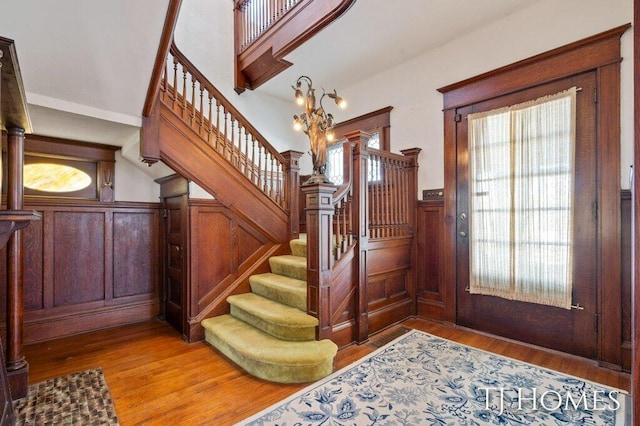 foyer entrance featuring a notable chandelier and wood-type flooring