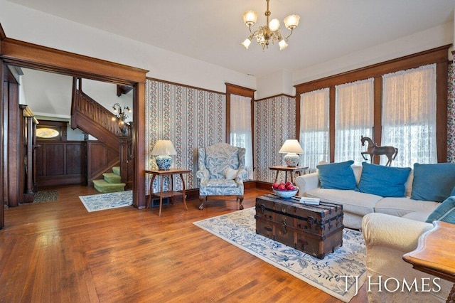 living room with hardwood / wood-style floors and a notable chandelier