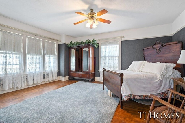 bedroom with hardwood / wood-style floors and ceiling fan