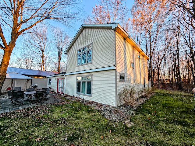 rear view of house with a patio area and a yard