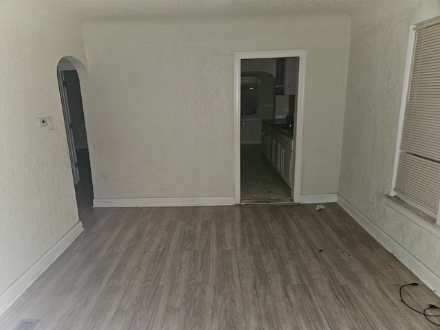 unfurnished room featuring dark hardwood / wood-style flooring