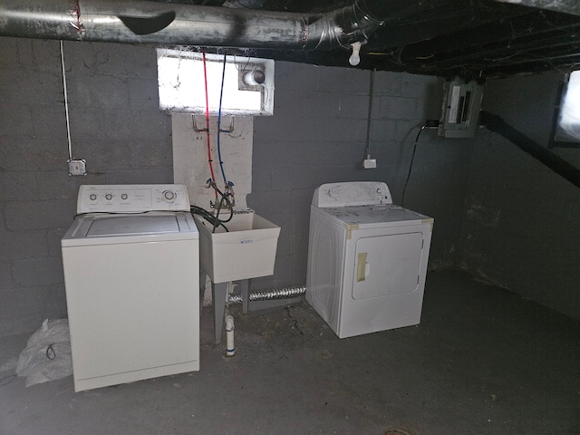 clothes washing area with sink, electric panel, and washing machine and clothes dryer