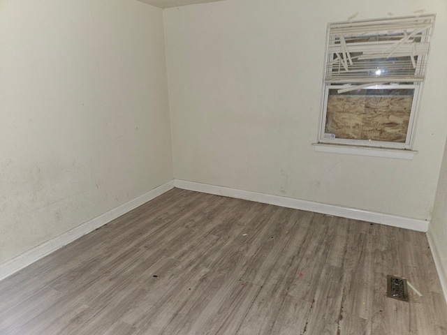 spare room with hardwood / wood-style flooring