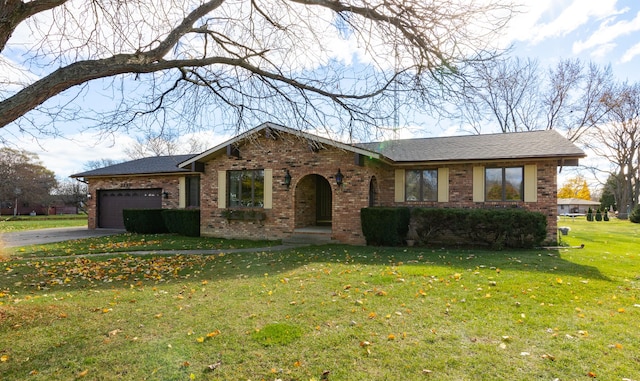 ranch-style house featuring a front yard and a garage