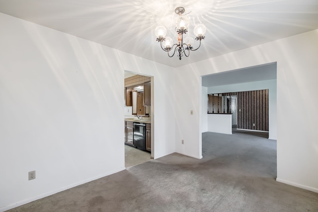 empty room featuring light carpet and an inviting chandelier