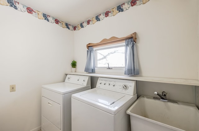 washroom featuring washer and dryer and sink