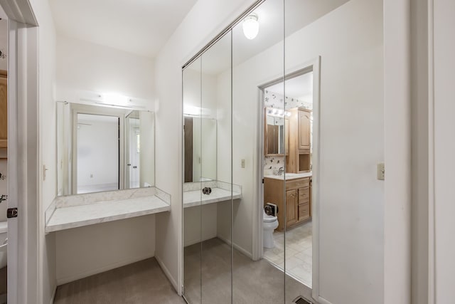 bathroom featuring vanity and toilet