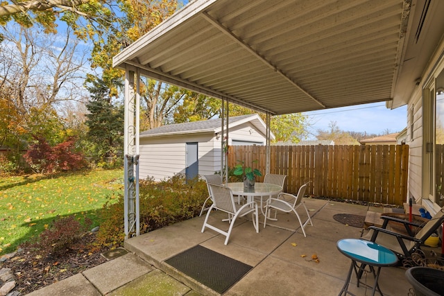 view of patio with outdoor dining space and fence