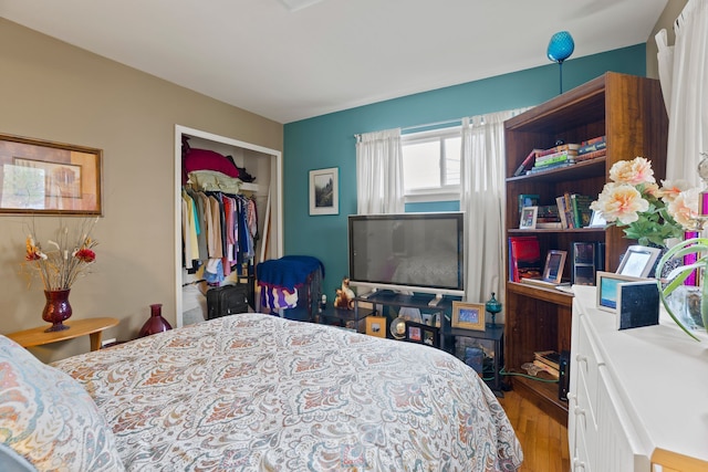 bedroom with a closet and wood finished floors