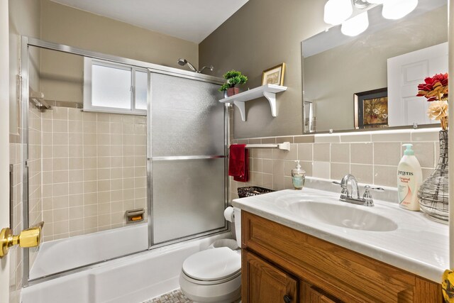 full bathroom featuring tasteful backsplash, vanity, tile walls, enclosed tub / shower combo, and toilet