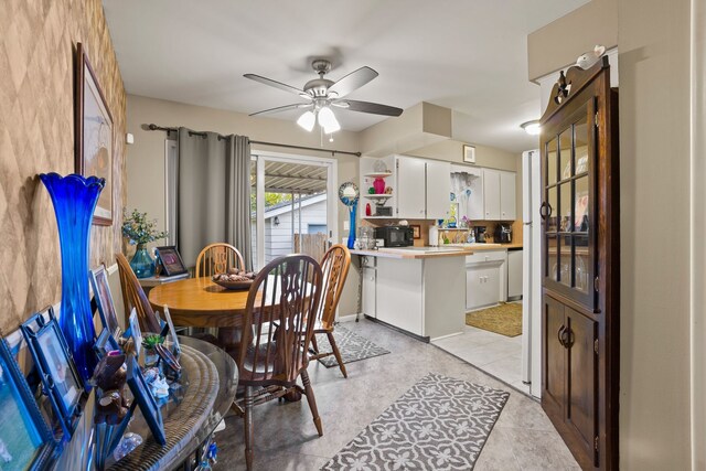 tiled dining space featuring ceiling fan