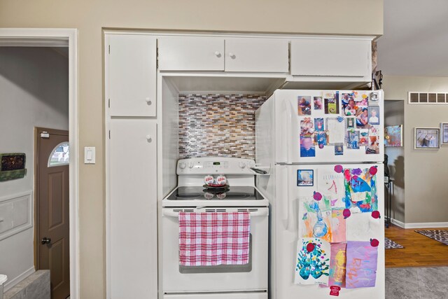 kitchen featuring white cabinets, white appliances, and light wood-type flooring