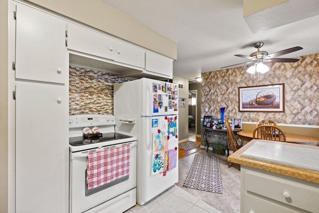 kitchen featuring light tile patterned floors, white appliances, white cabinetry, light countertops, and backsplash