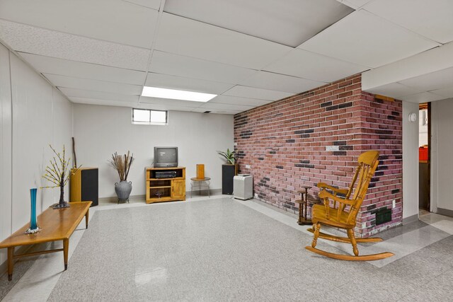 sitting room featuring a drop ceiling