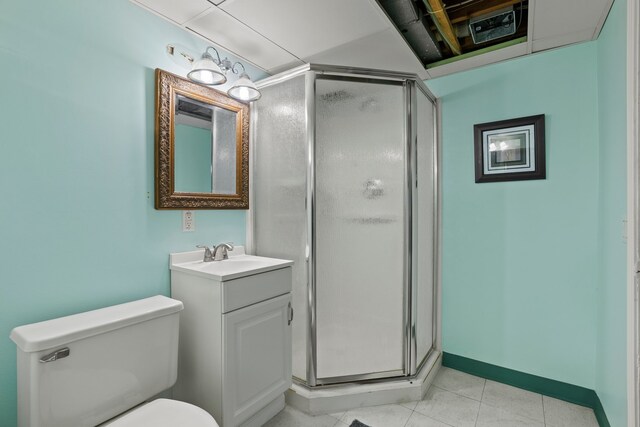 bathroom featuring tile patterned floors, vanity, an enclosed shower, and toilet