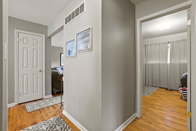 corridor with light hardwood / wood-style flooring