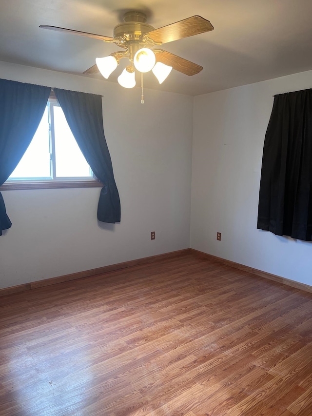 empty room featuring ceiling fan and hardwood / wood-style flooring