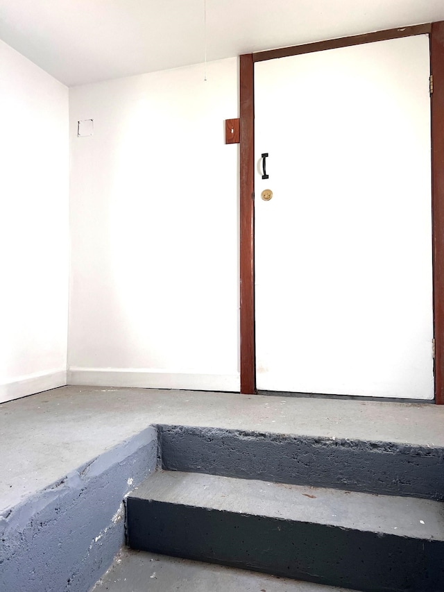 staircase with concrete flooring