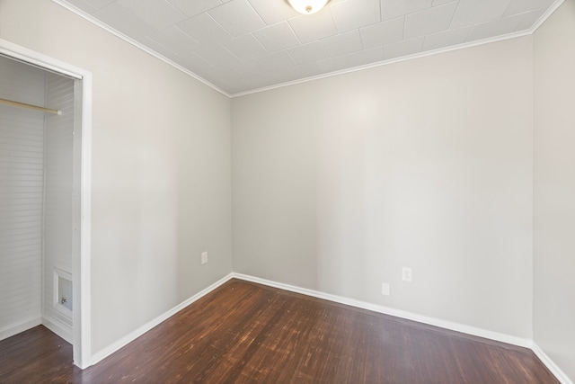 unfurnished room featuring dark hardwood / wood-style flooring and crown molding