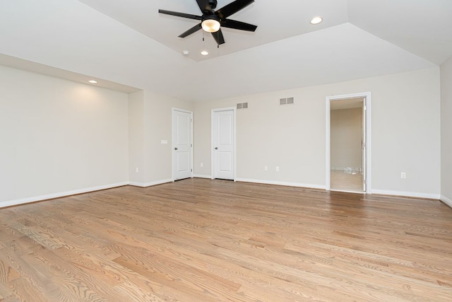 unfurnished room featuring light wood-type flooring, vaulted ceiling, and ceiling fan