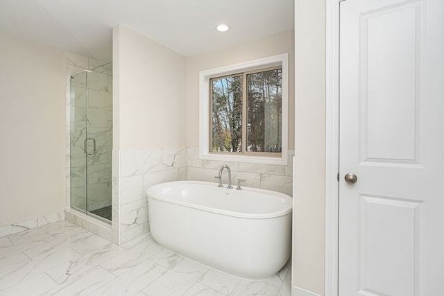 bathroom featuring separate shower and tub and tile walls