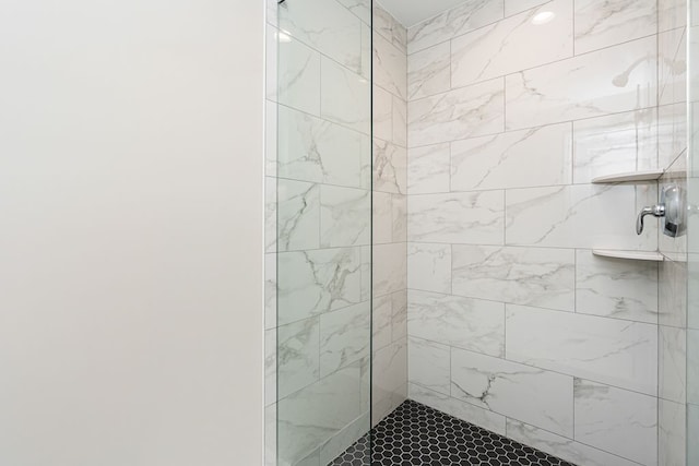 bathroom with a tile shower