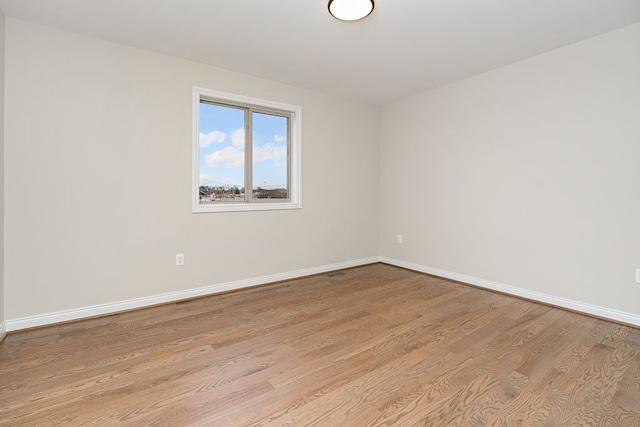 unfurnished room with light hardwood / wood-style floors