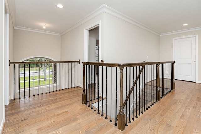 hall with light wood-type flooring and crown molding