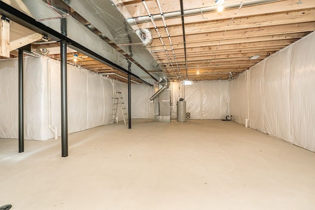 basement featuring gas water heater and heating unit