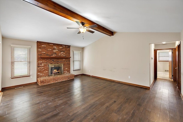 unfurnished living room with ceiling fan, lofted ceiling with beams, dark hardwood / wood-style floors, and a brick fireplace