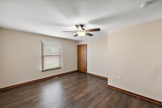 empty room with dark hardwood / wood-style flooring and ceiling fan