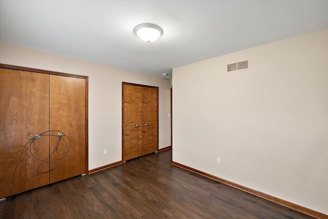 unfurnished bedroom featuring dark wood-type flooring