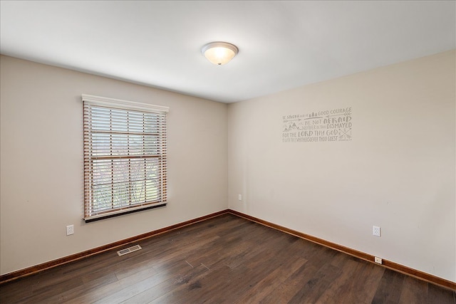 unfurnished room with dark wood-type flooring