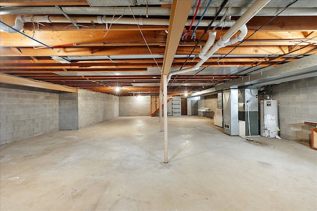 basement featuring heating unit and water heater