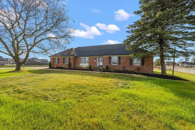 ranch-style home with a front lawn