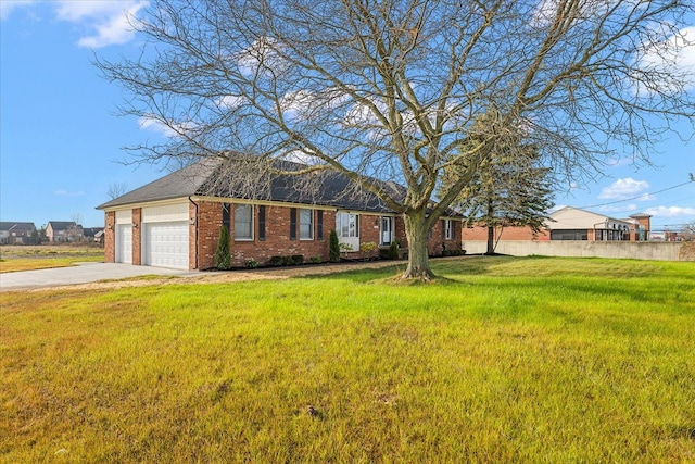 ranch-style home featuring a front lawn and a garage