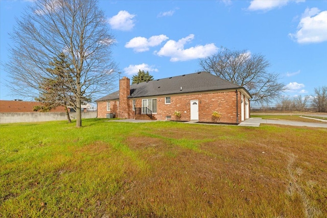 rear view of house with a yard