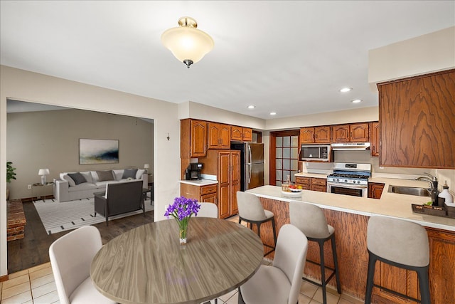 dining room with light hardwood / wood-style flooring and sink