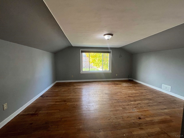 bonus room featuring dark hardwood / wood-style flooring and lofted ceiling