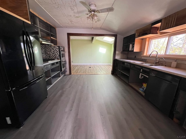 kitchen with ceiling fan, sink, black appliances, light hardwood / wood-style flooring, and lofted ceiling