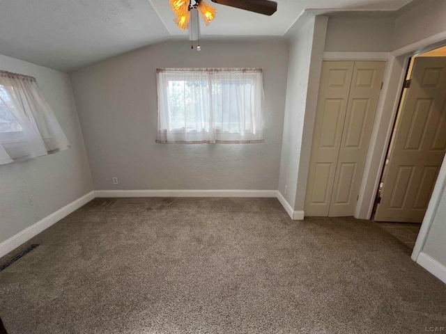 unfurnished room with a textured ceiling, ceiling fan, lofted ceiling, and carpet floors