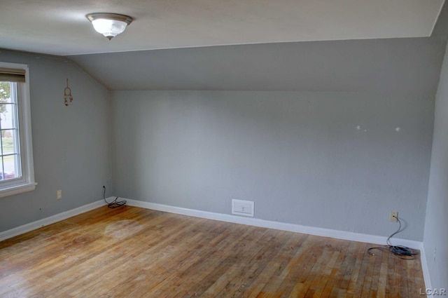 bonus room featuring light wood-type flooring and lofted ceiling