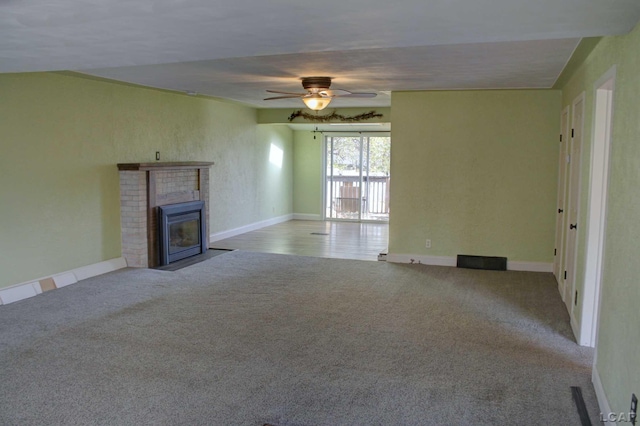 unfurnished living room featuring light carpet and ceiling fan